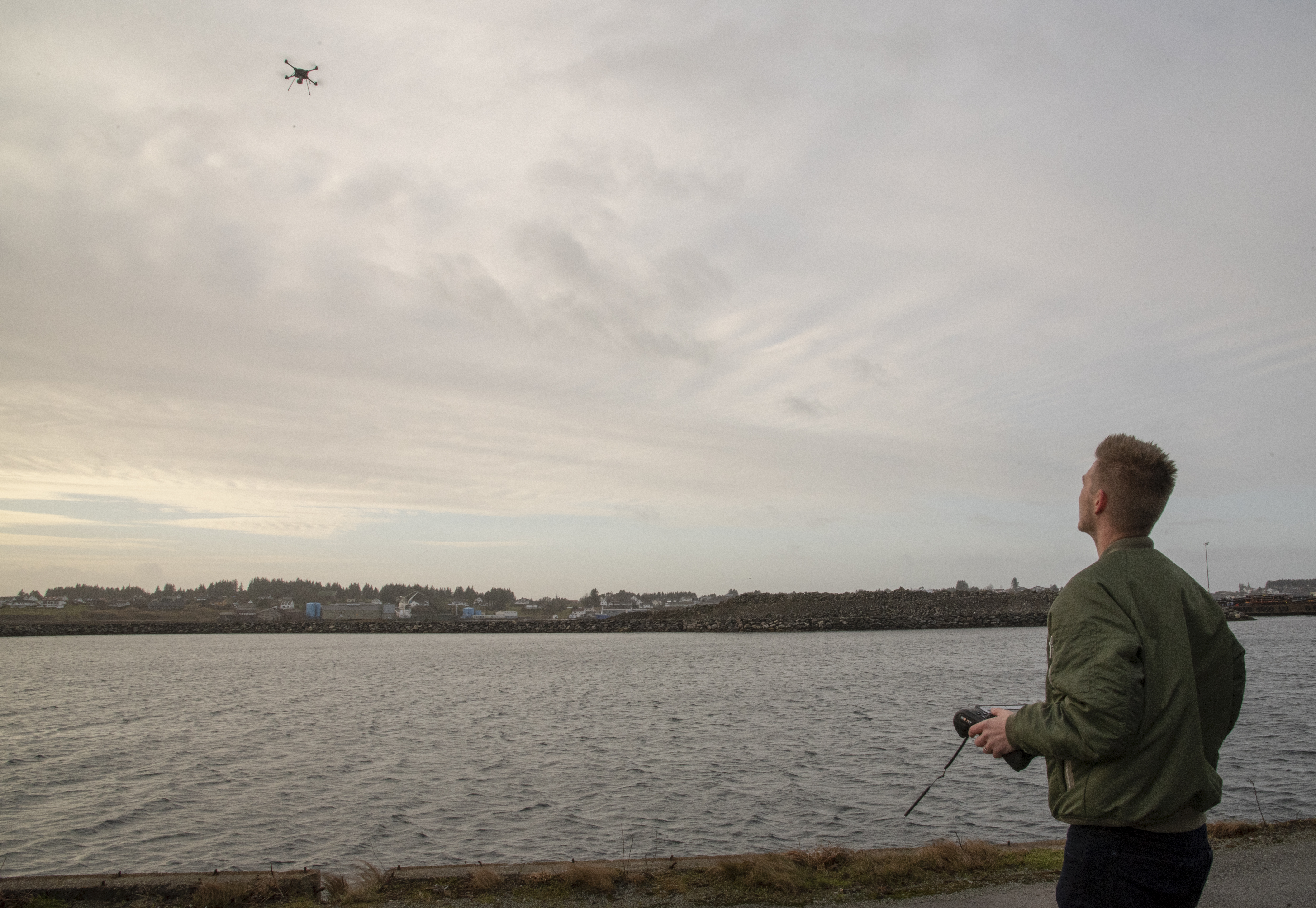 Man flying a drone over the sea